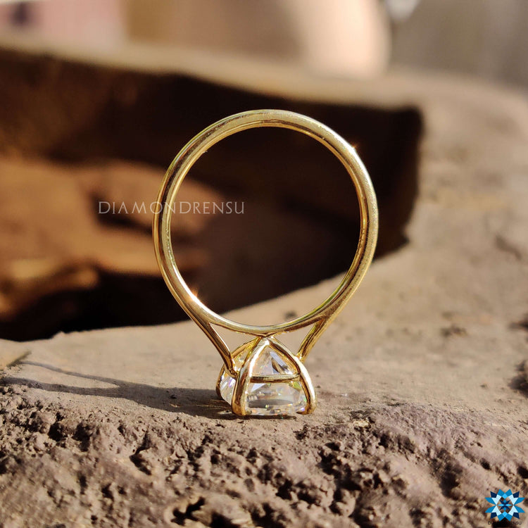 Yellow gold moissanite ring in cathedral mount.