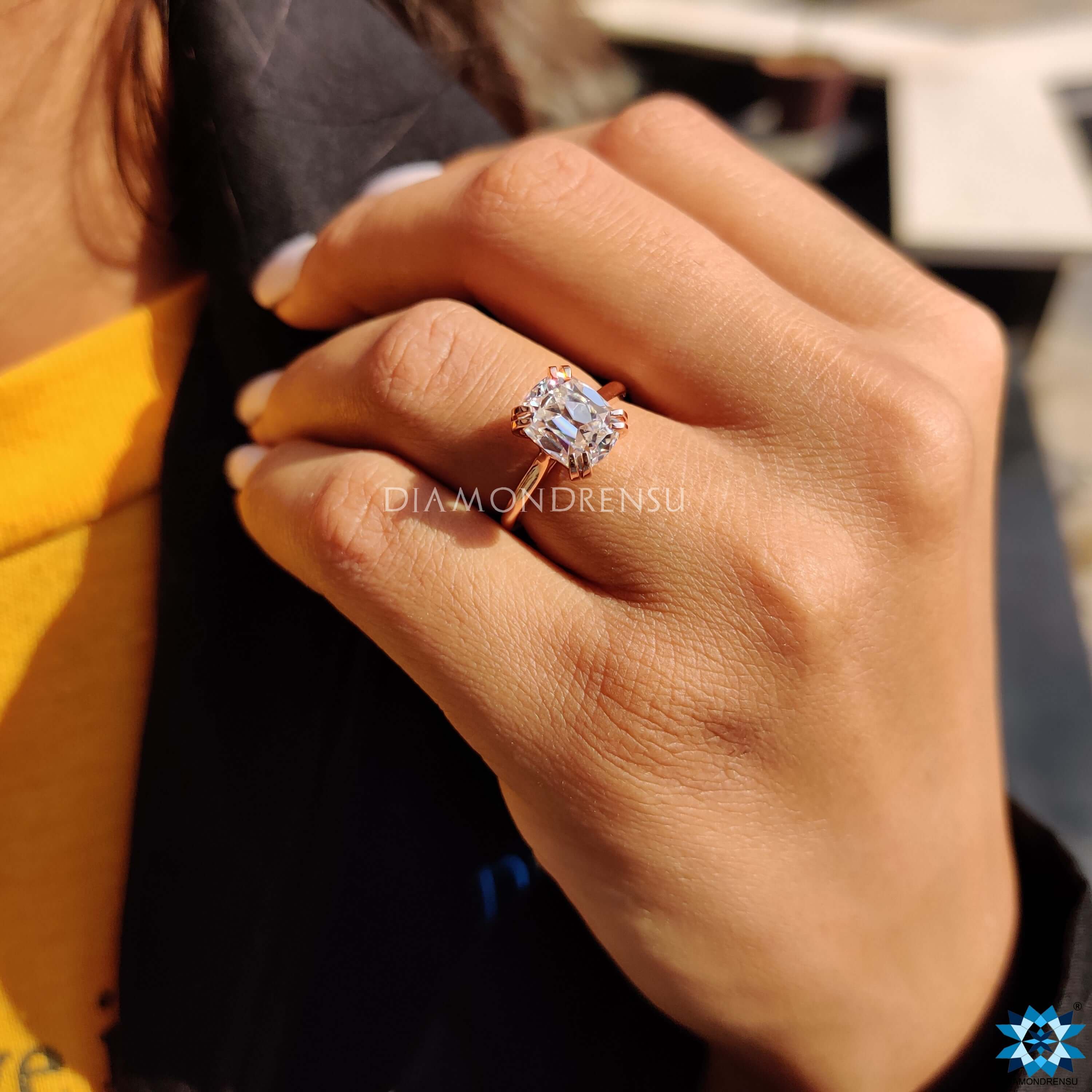 Prong setting rose gold ring with old European cut moissanite.