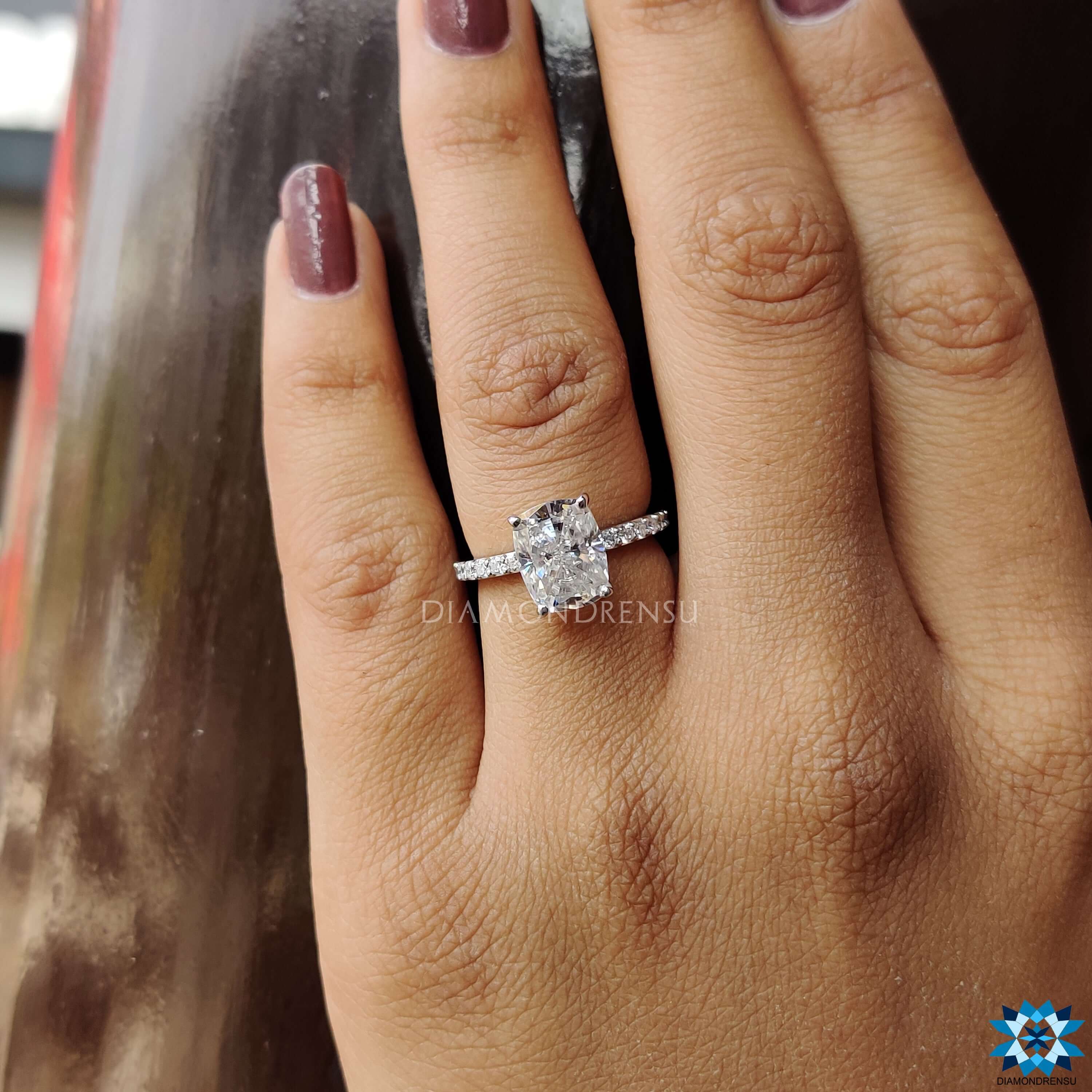 Prong setting engagement ring with round cut accents.