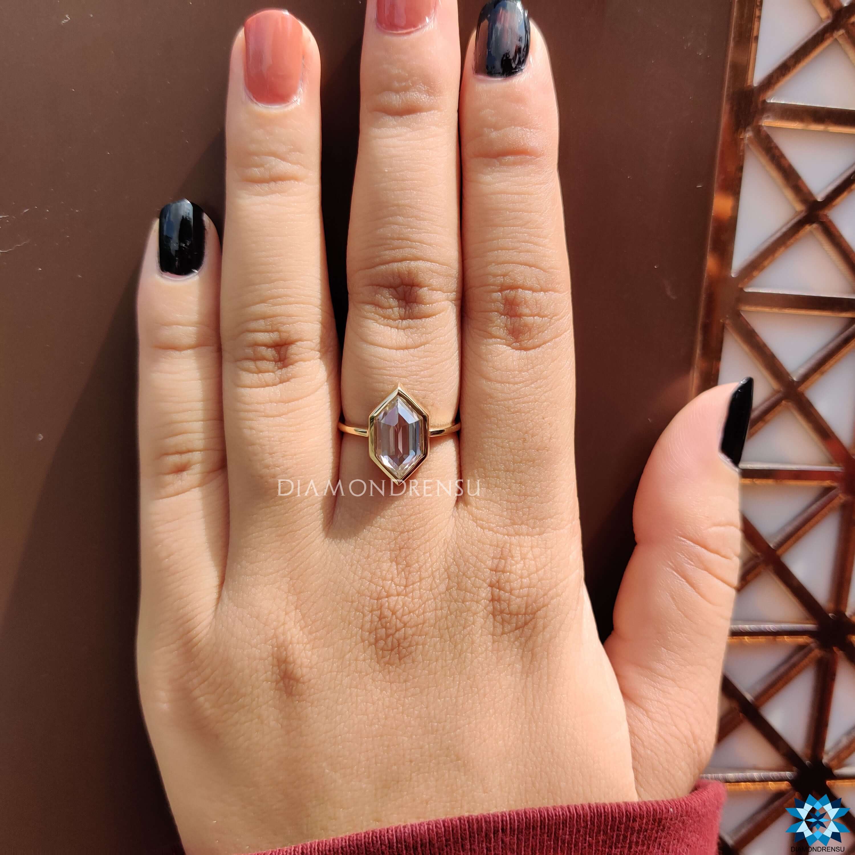 White gold solitaire ring with hexagon cut moissanite.