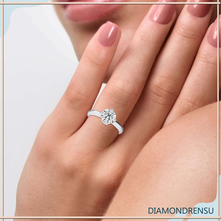 Rose gold engagement ring with compass prong setting.
