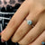 Round brilliant cut engagement ring featuring a blue moissanite ring centre. Round brilliant cut engagement ring featuring a blue moissanite ring centre.