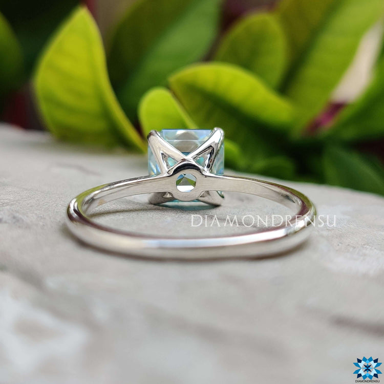 White gold ring featuring Asscher cut blue moissanite center.
