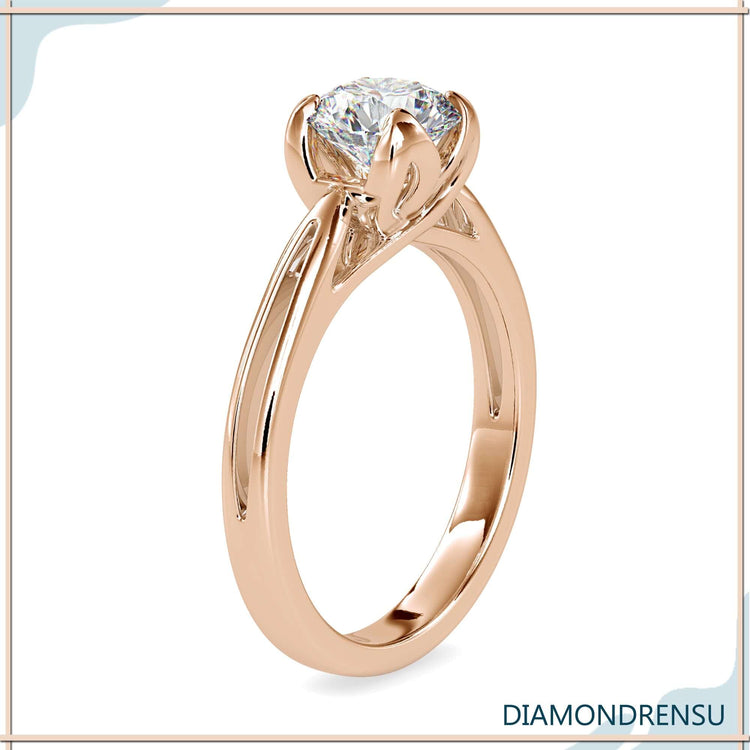 Round diamond ring with soft petal claws and high mount.