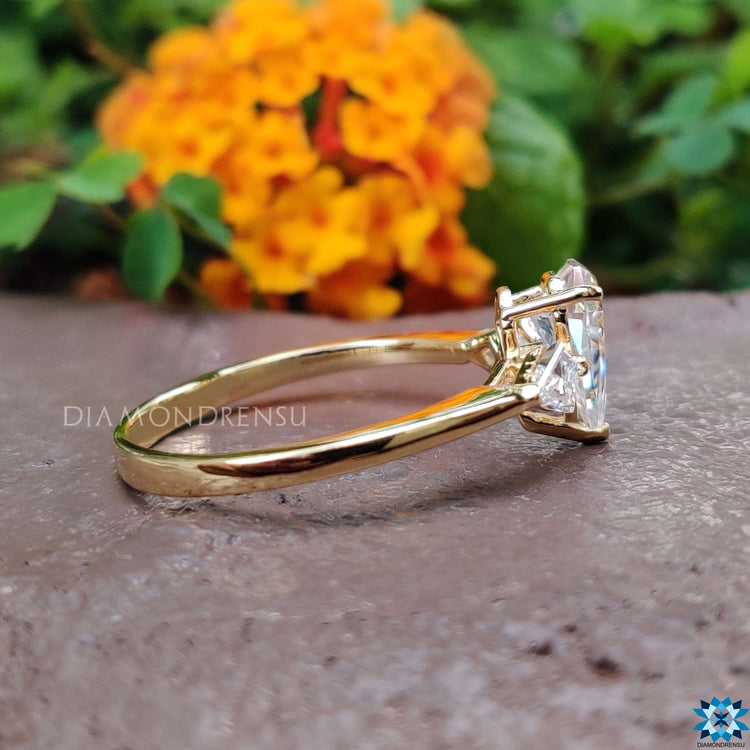 Custom engagement ring with kite cut side stones.