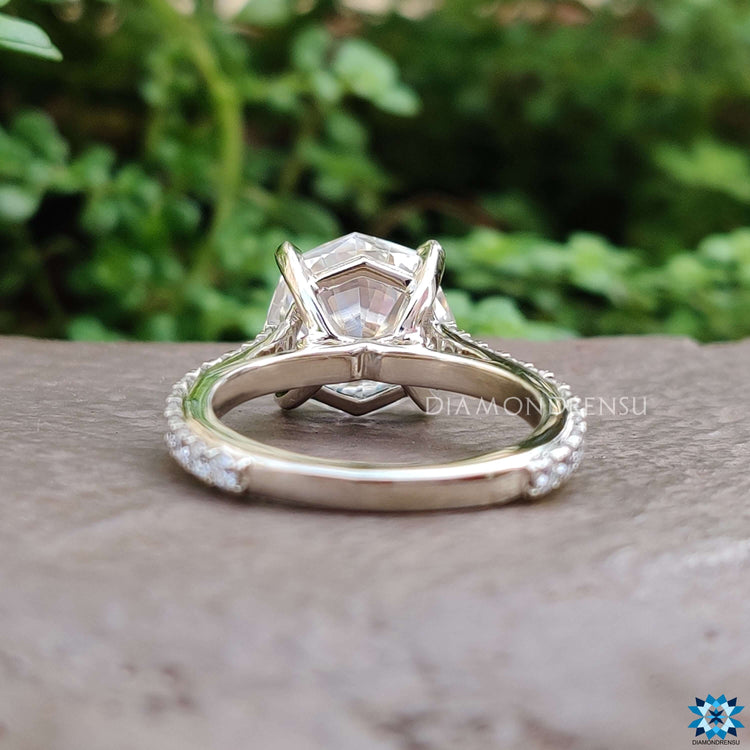 Moissanite ring with round cut pave band in white gold.