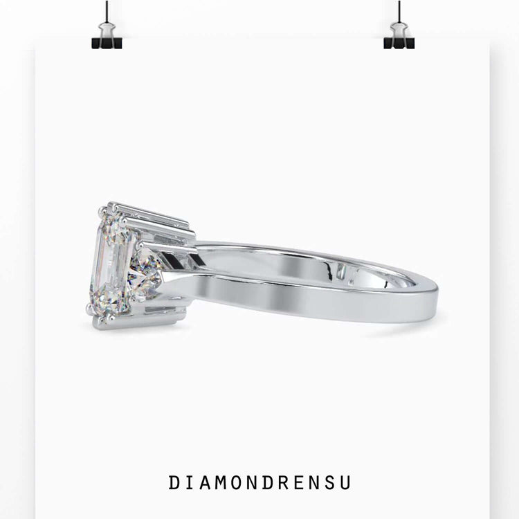 Prong setting engagement ring with 3 diamonds.