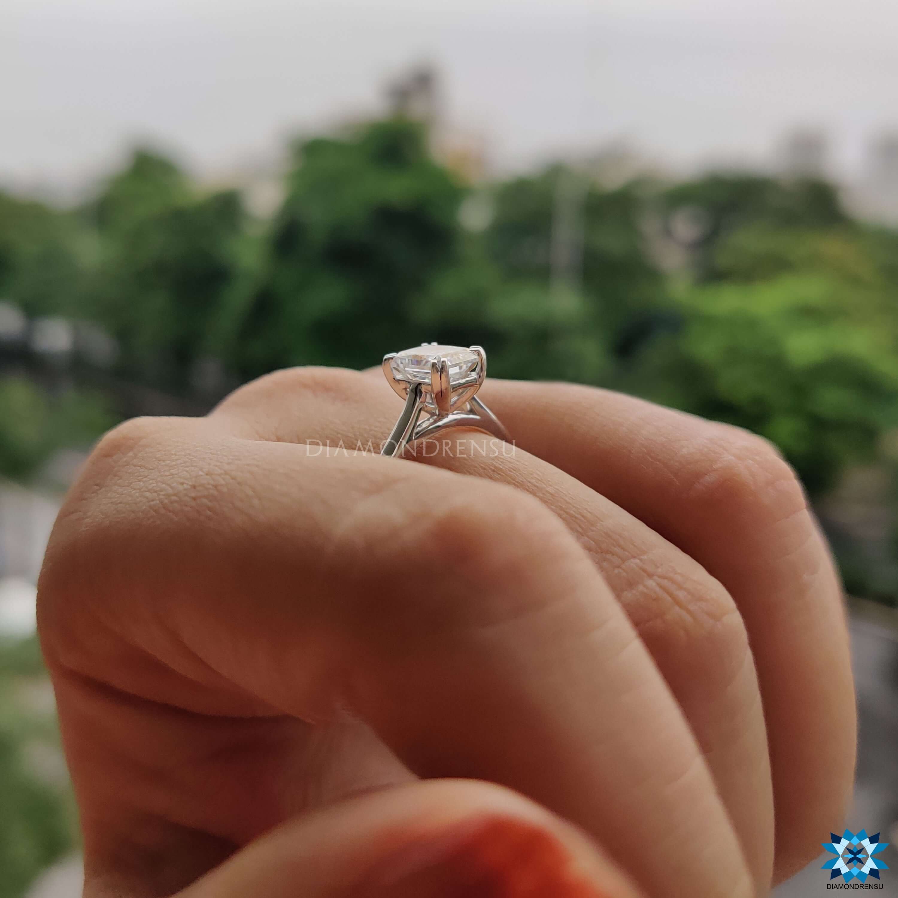 White gold radiant cut engagement ring with double claw prongs.
