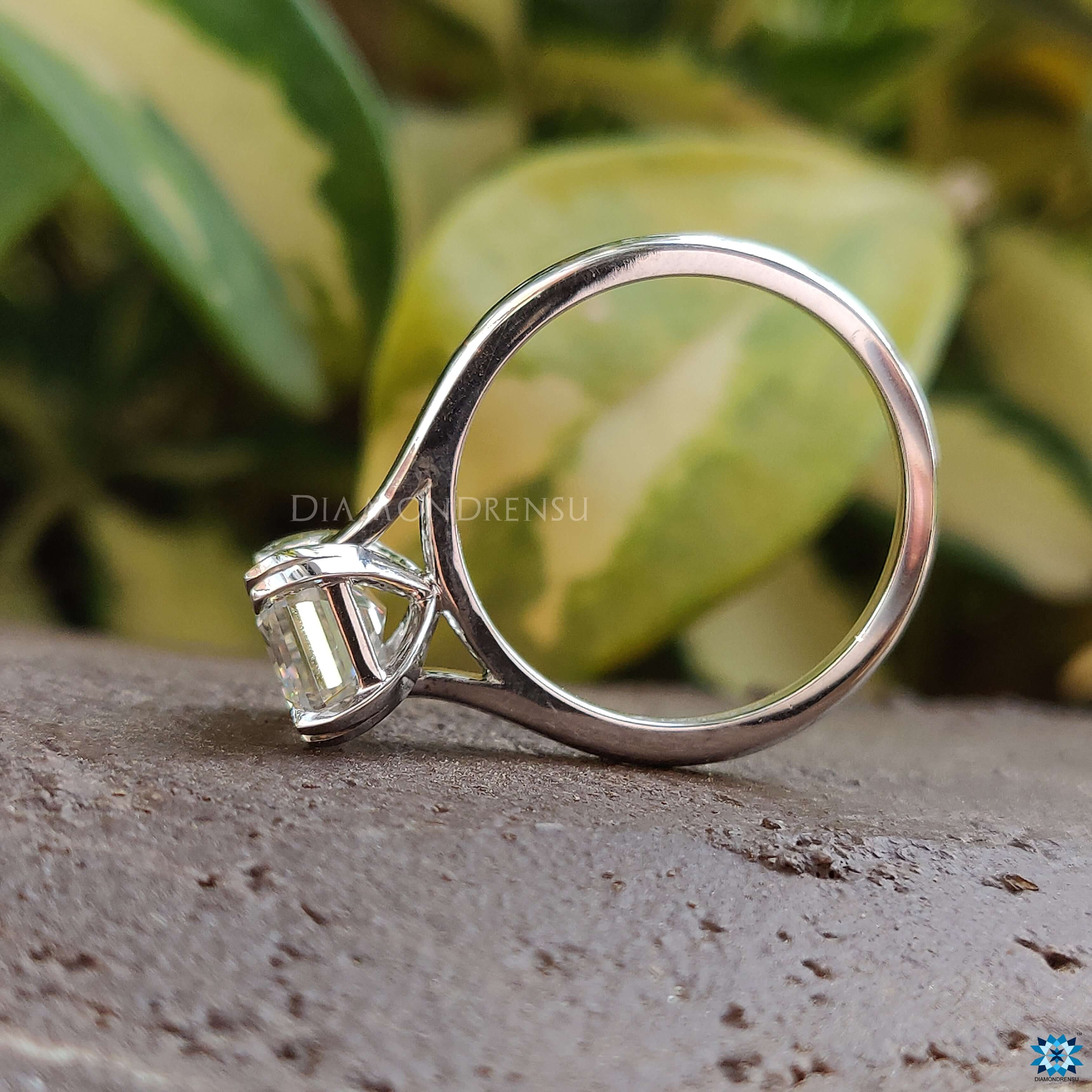 Custom engagement ring featuring emerald cut moissanite.