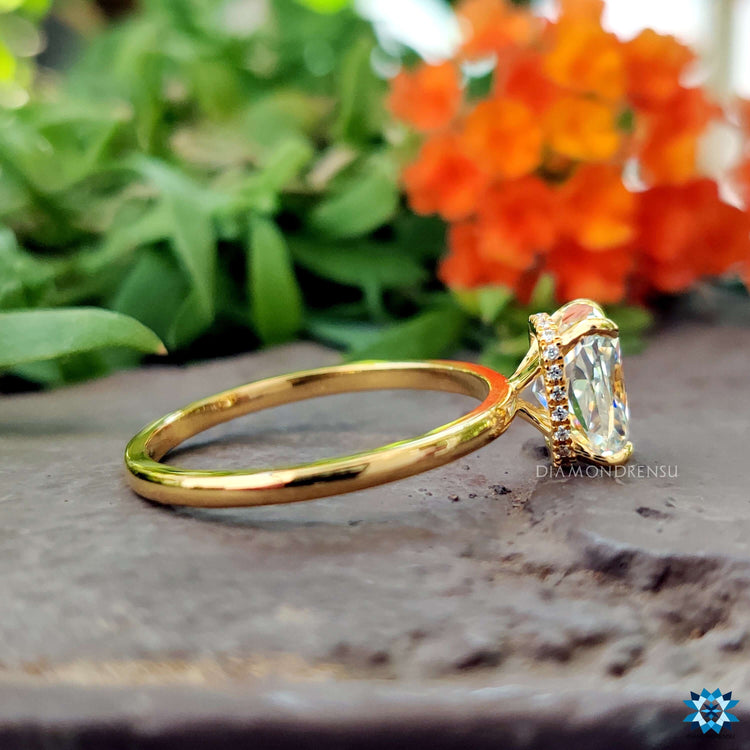 Handmade white gold ring featuring elongated cushion moissanite.