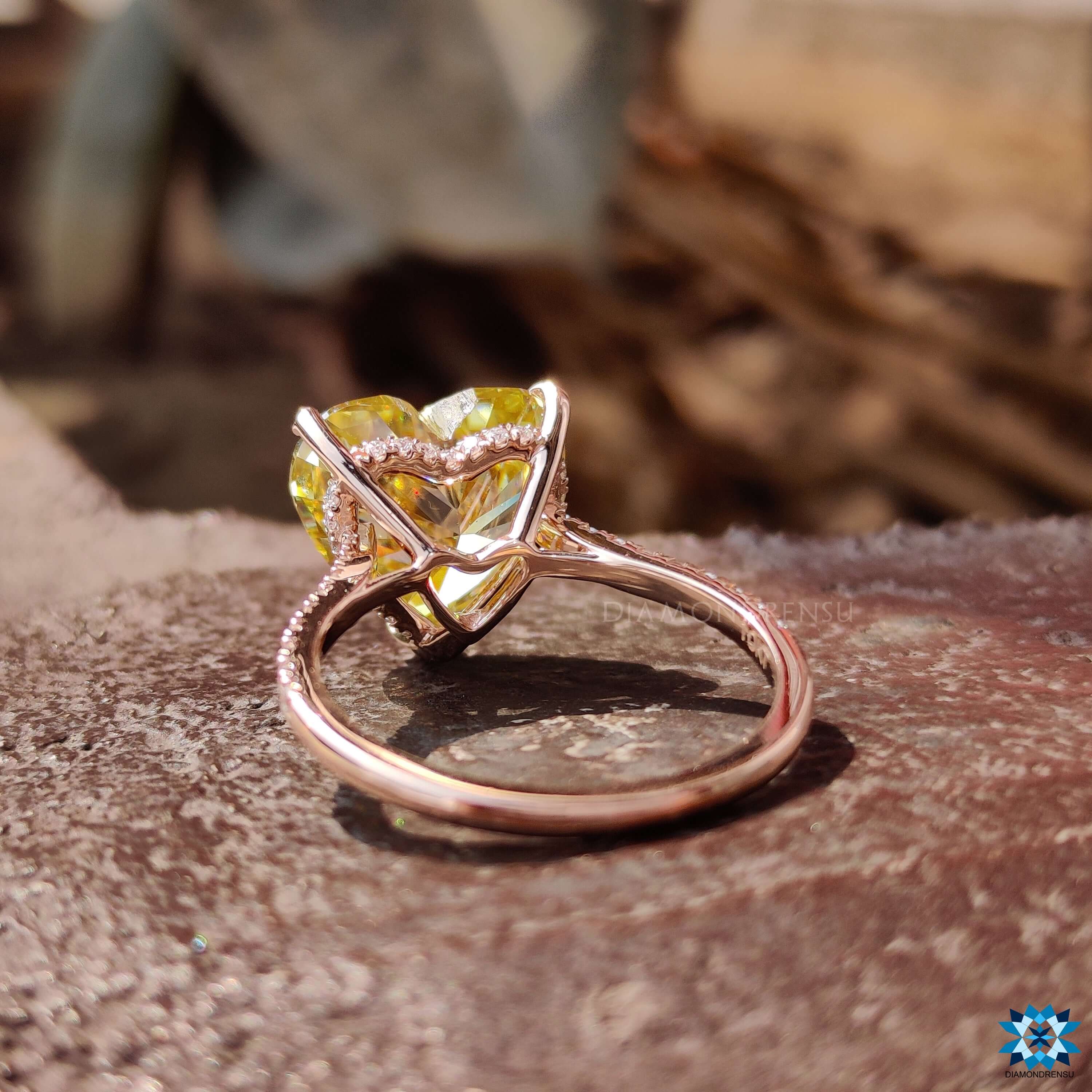 Rose gold moissanite ring with claw prong setting.