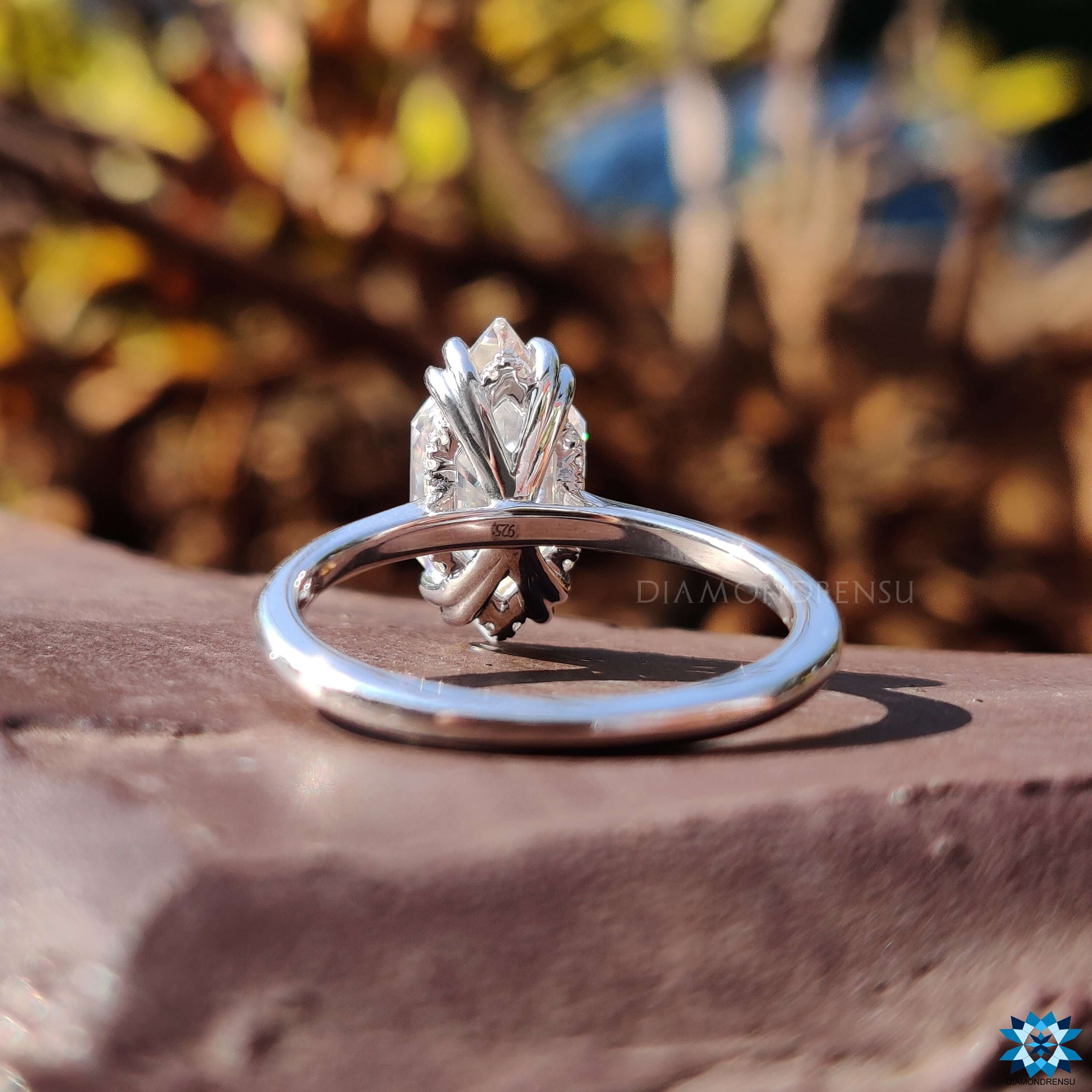 Double claw prong setting on marquise moissanite ring.