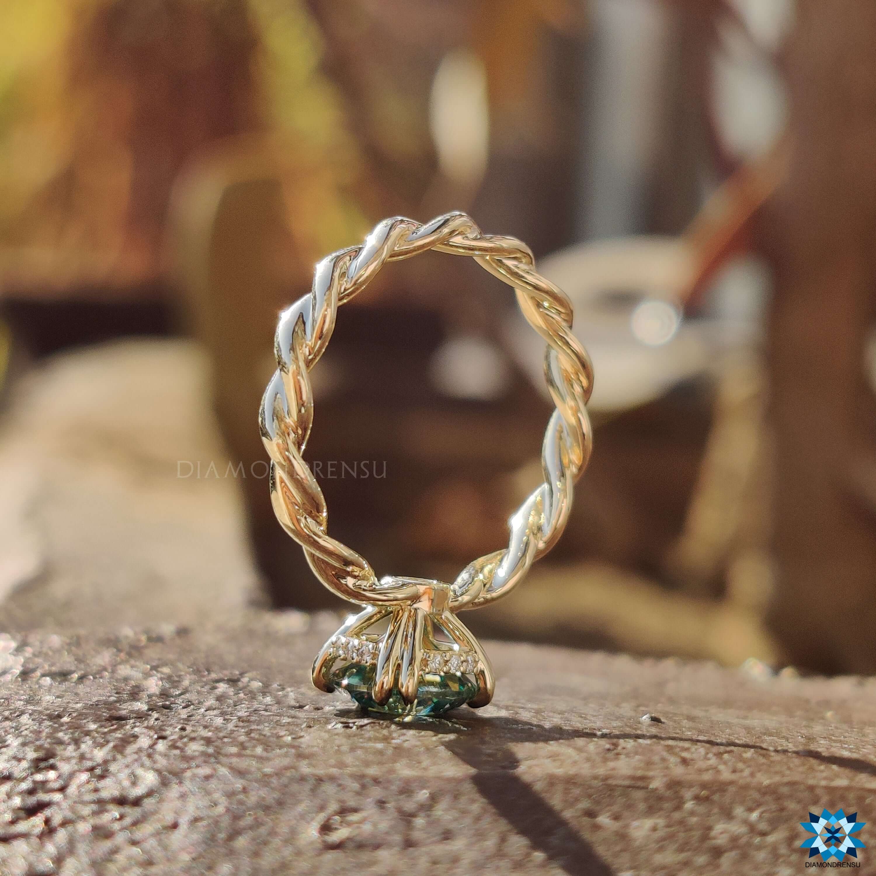 Custom moissanite engagement ring with twisted band design.