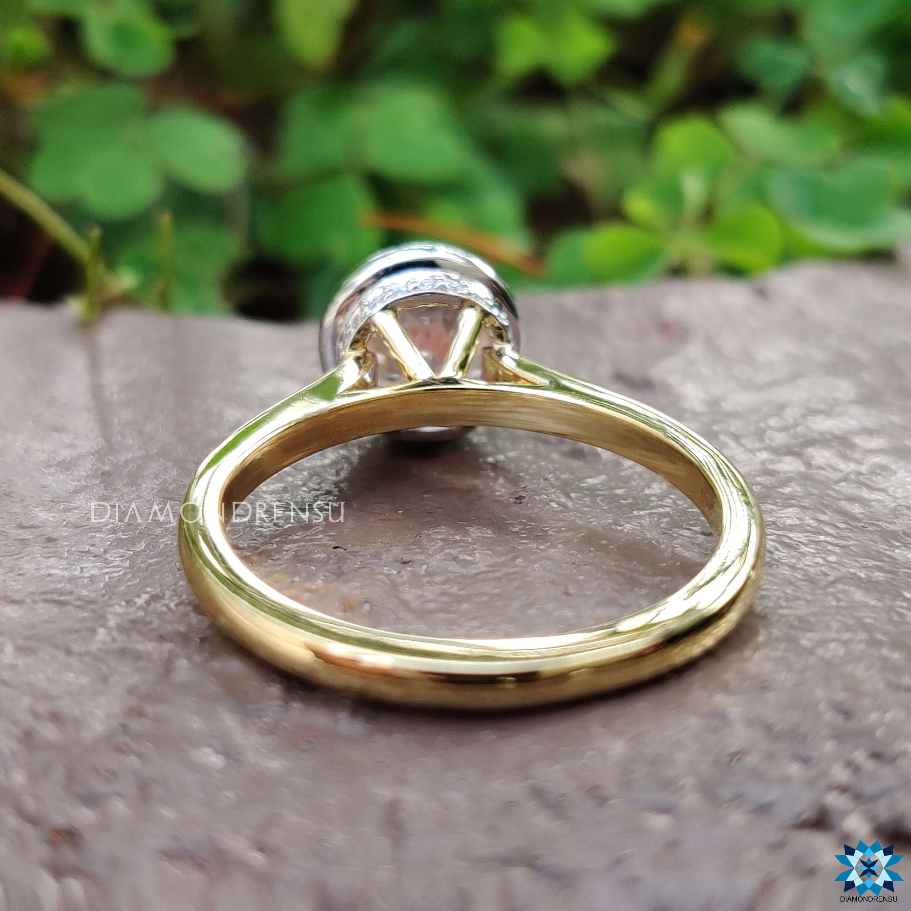 Round cut moissanite ring in yellow gold cathedral design.