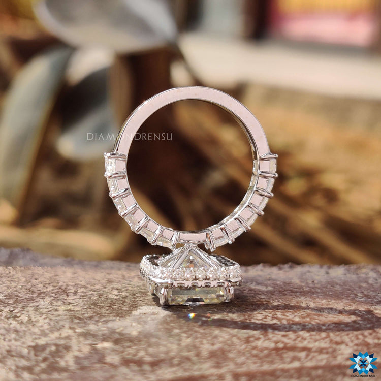 Radiant cut moissanite ring with round pave halo and prong setting.