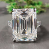 Three stone gold ring with emerald cut center.
