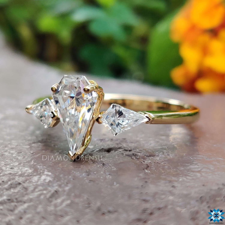 Yellow gold ring with spear cut center stone.