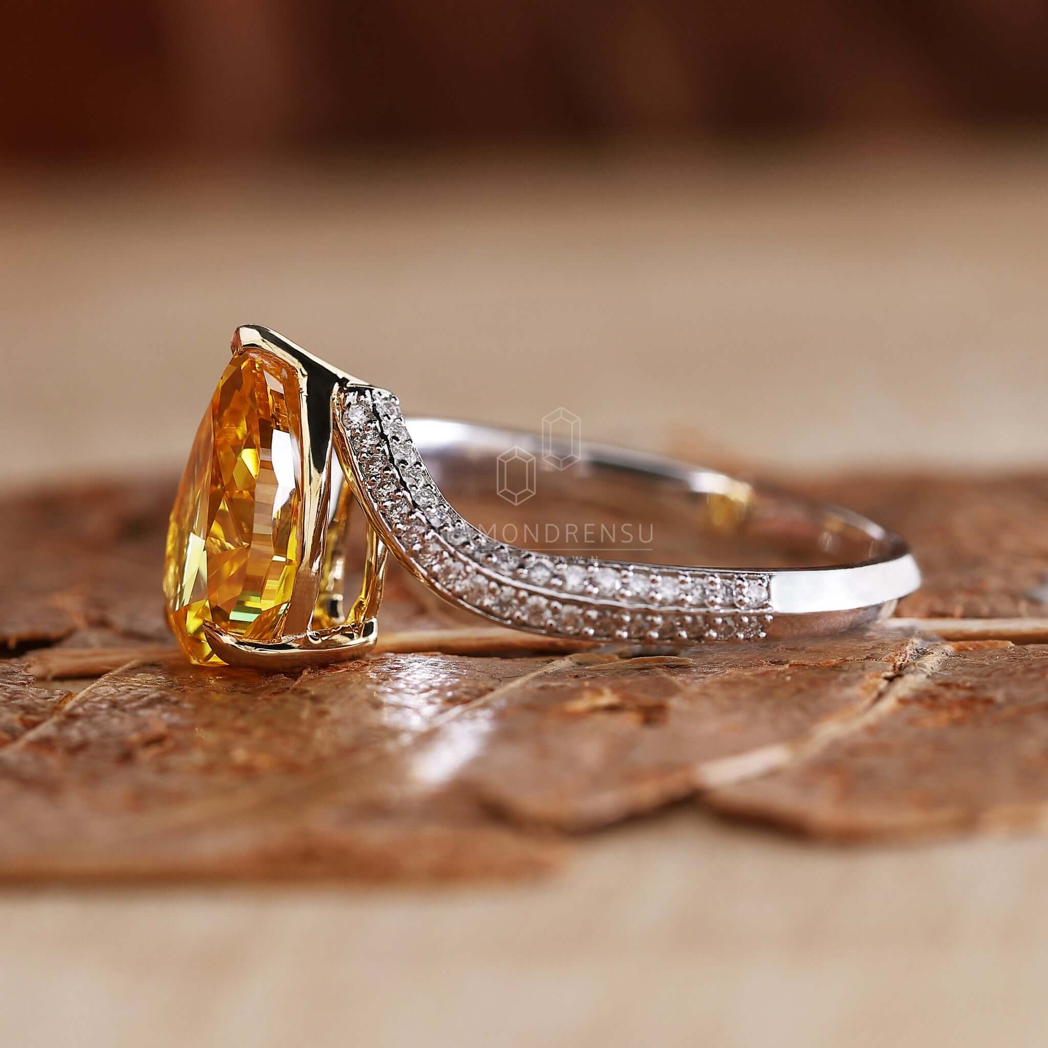 Pear diamond engagement ring featuring a claw prong setting