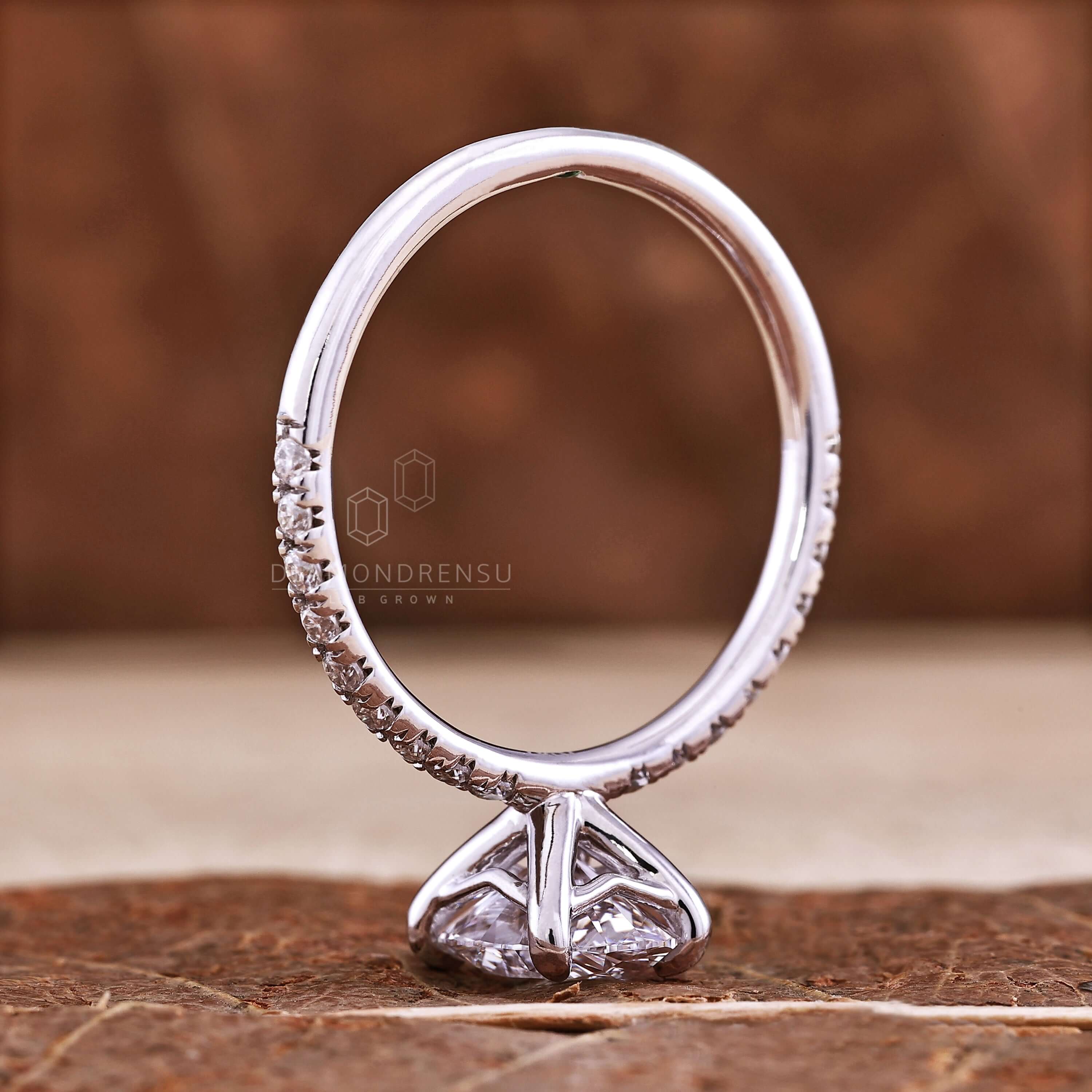 Unique engagement ring with handmade jewelry details, showcasing an elegant oval diamond.