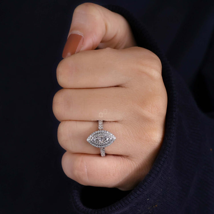 Marquise cut diamond set in a pave diamond ring with a cathedral setting style.