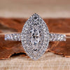 Marquise diamond ring with pave diamond accents in a unique engagement ring design.