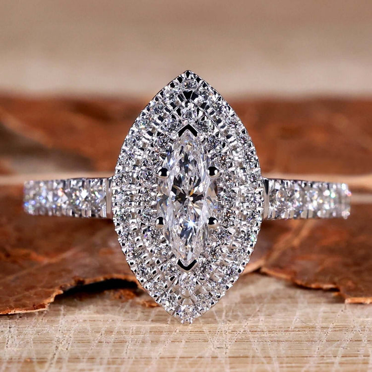 Marquise diamond ring with pave diamond accents in a unique engagement ring design.