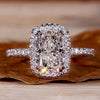 Cushion engagement ring with halo and double claw prong in a pave diamond ring design for timeless elegance.