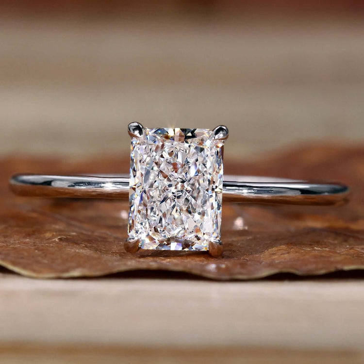 Solitaire engagement ring with a radiant cut diamond in a timeless design.