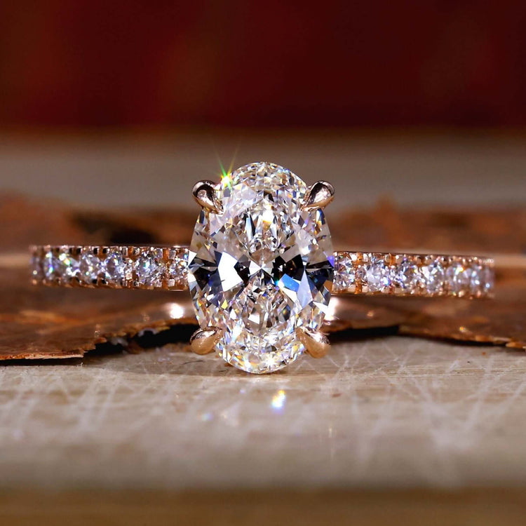 Oval diamond engagement ring with a stunning hidden halo design and elegant pave setting, perfect for proposals.