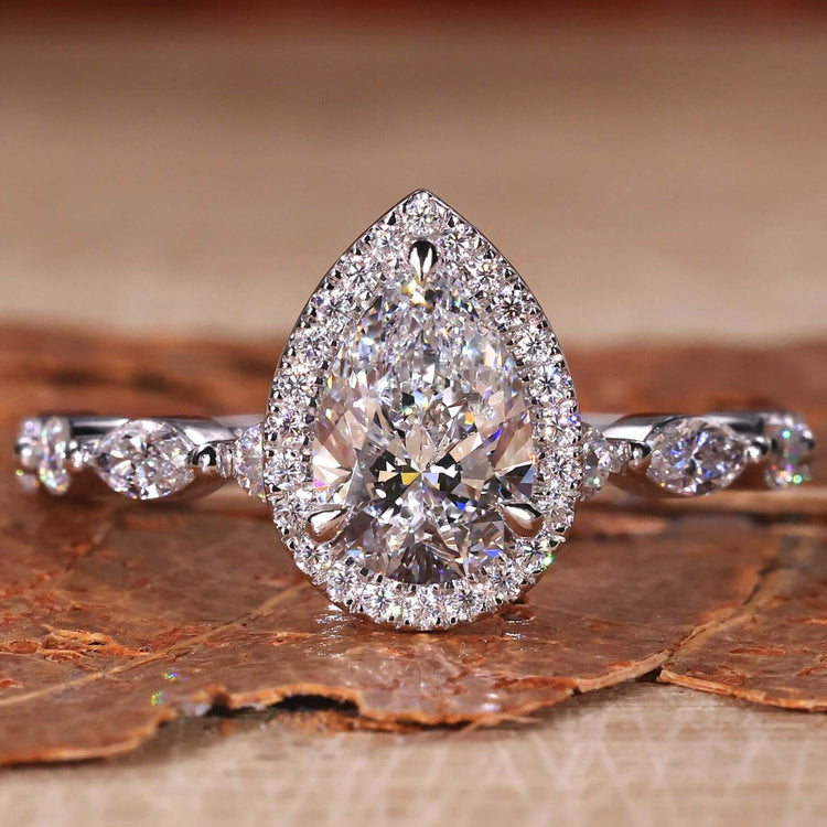 Pear Shaped Engagement Ring with a stunning halo ring setting and bubble prongs pave setting for a classic look.