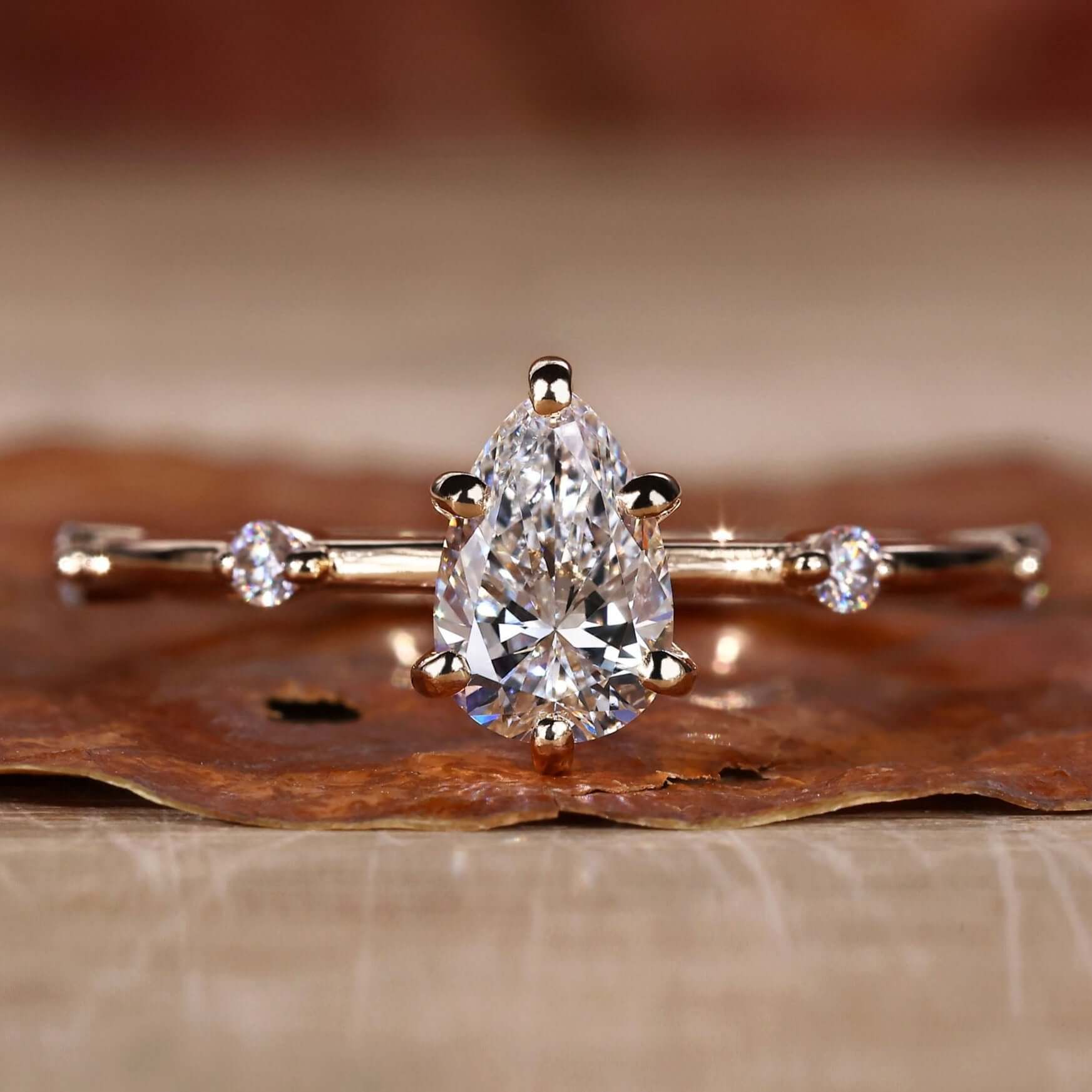 Pear shaped diamond ring with a pave ring design, perfect for elegant engagement moments and timeless beauty.