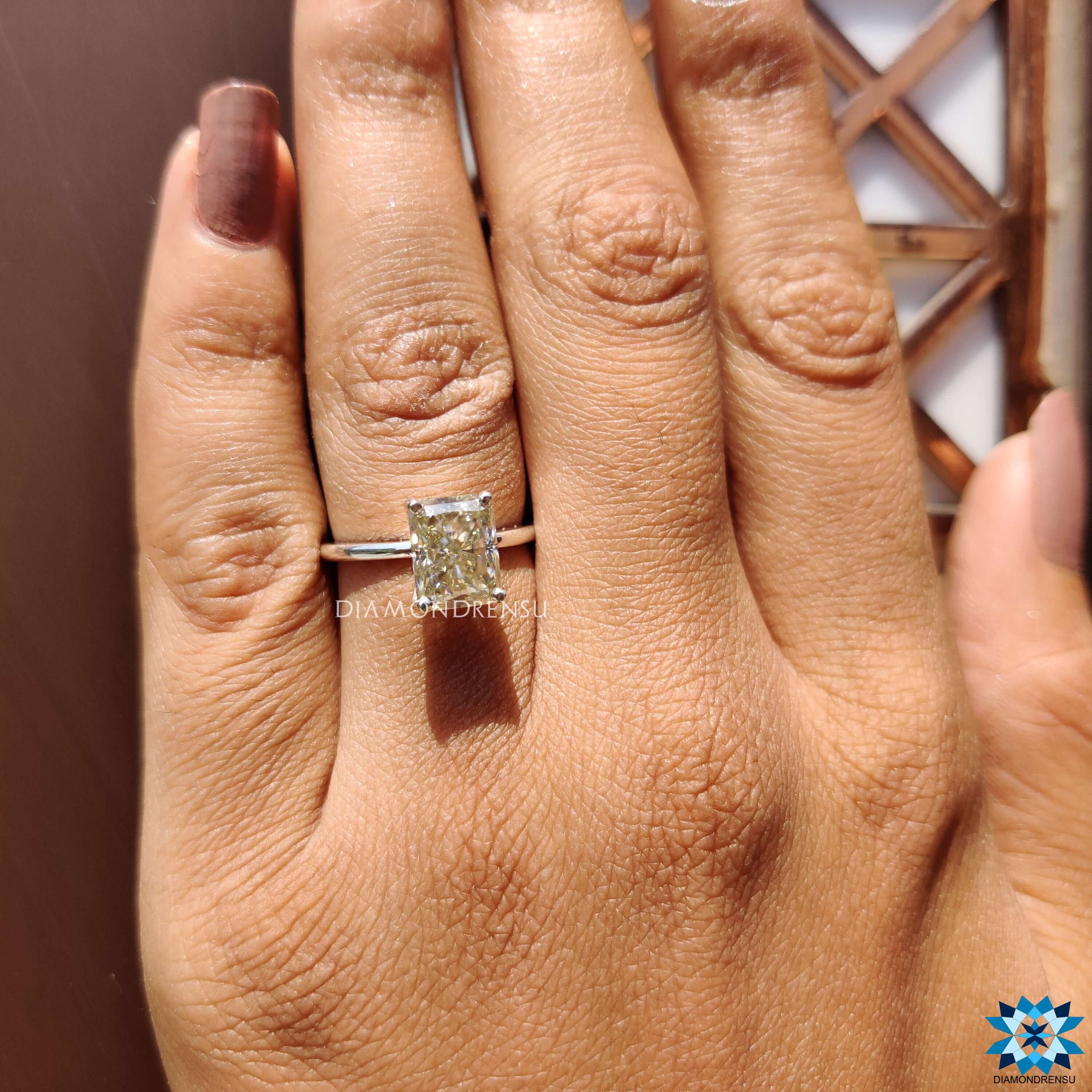 Buy moissanite ring with radiant cut stone set in 4 prong solitaire white gold ring.