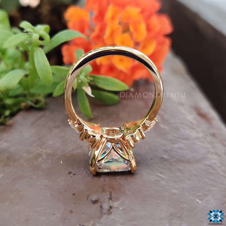 Handmade ring crafted in yellow gold featuring round and marquise side stones.
