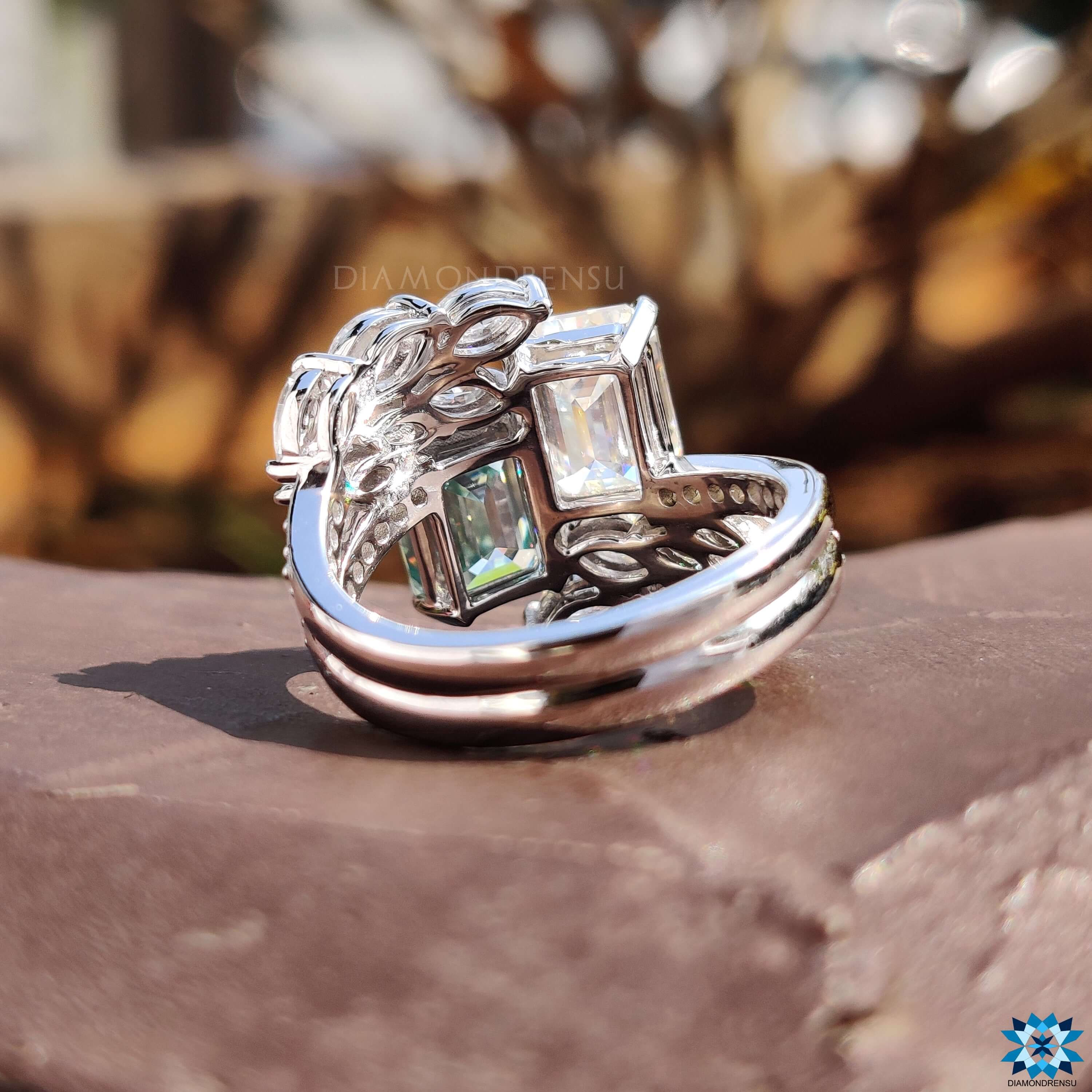 Prong set emerald moissanite ring in white gold.