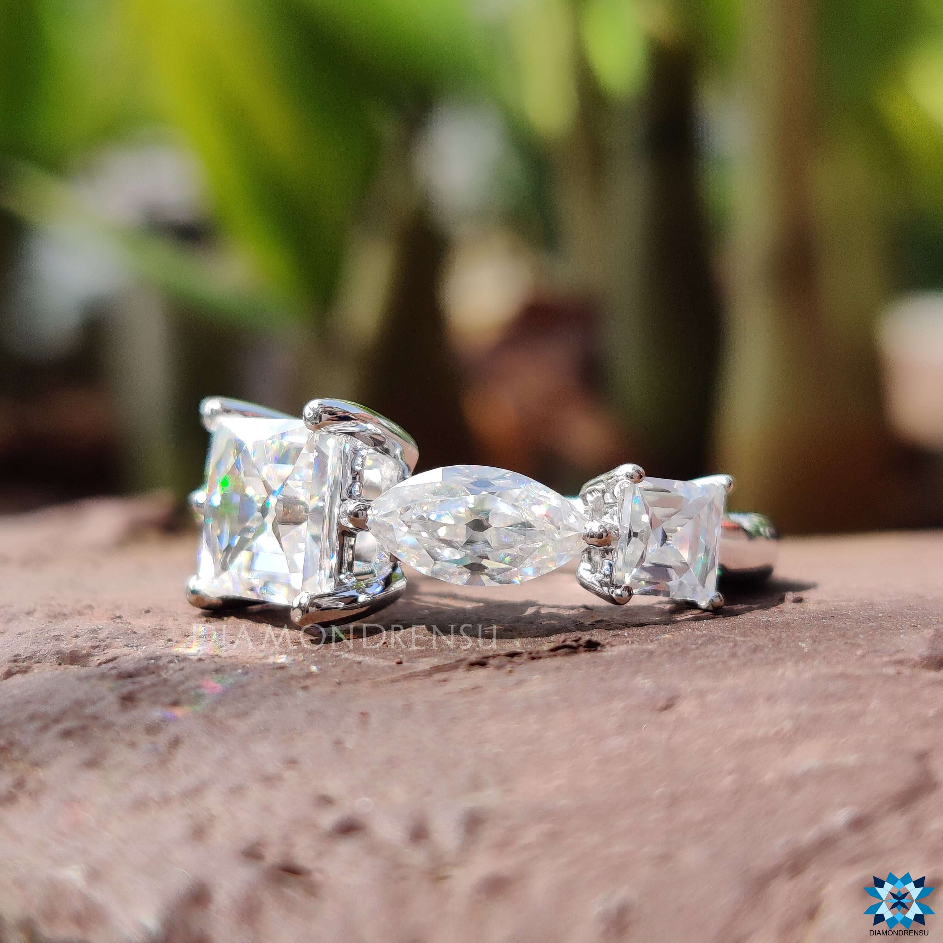 Side stone marquise old European cut ring in white gold.