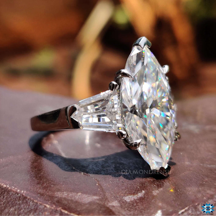 Handmade engagement ring with unique three-stone silhouette in moissanite.