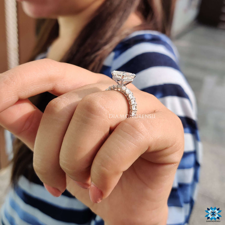 Handmade moissanite engagement ring with pave details.