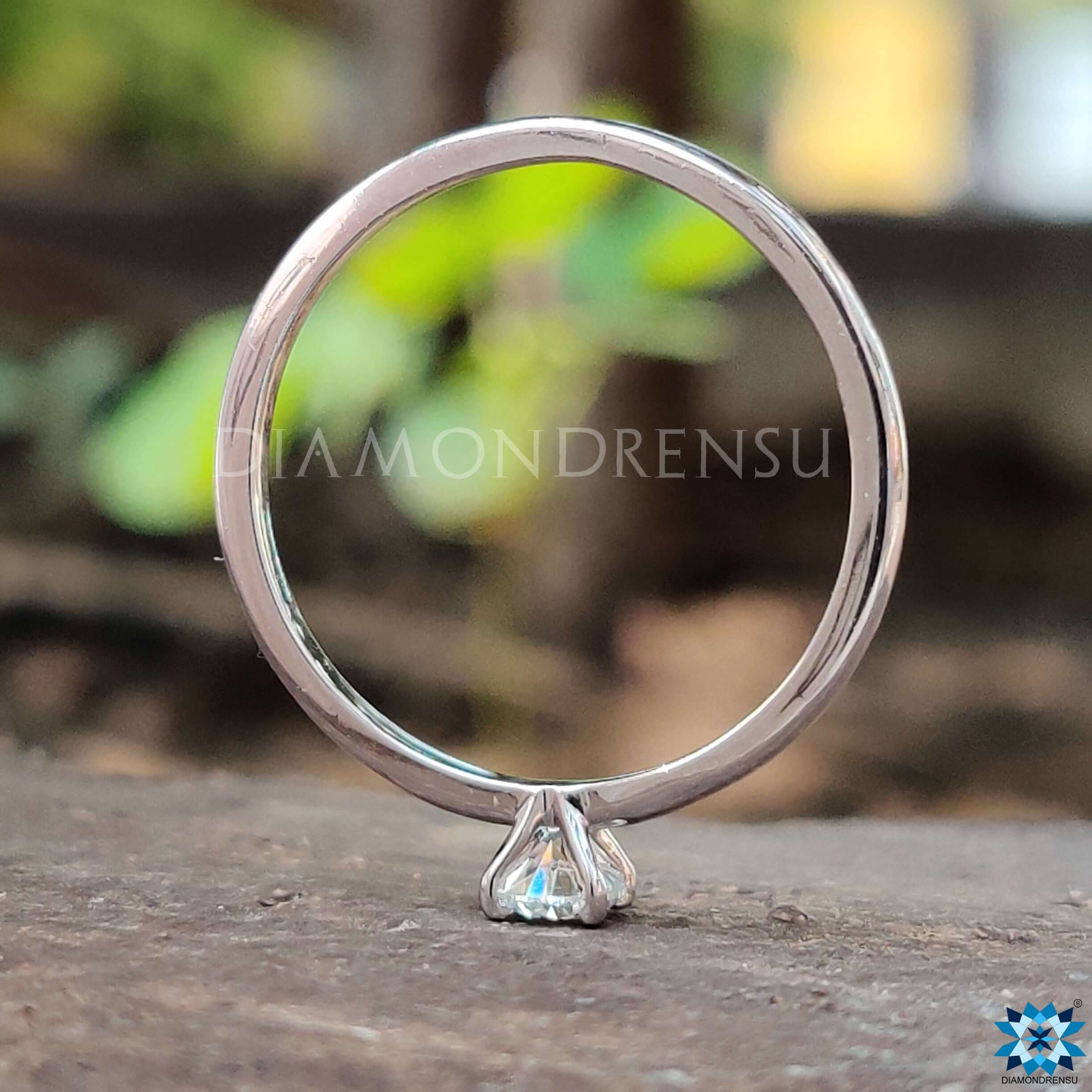 Simple round cut moissanite solitaire ring.