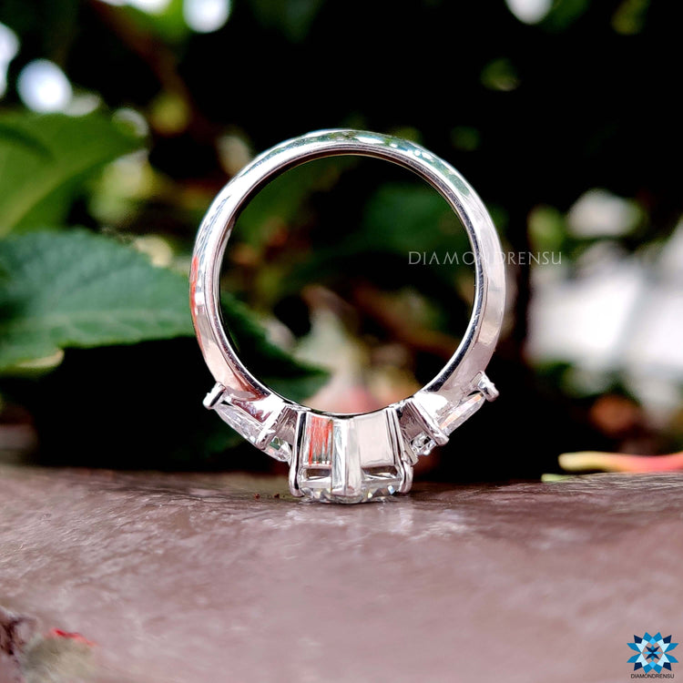 Prong setting ring with handmade design and custom-cut moissanite stones.