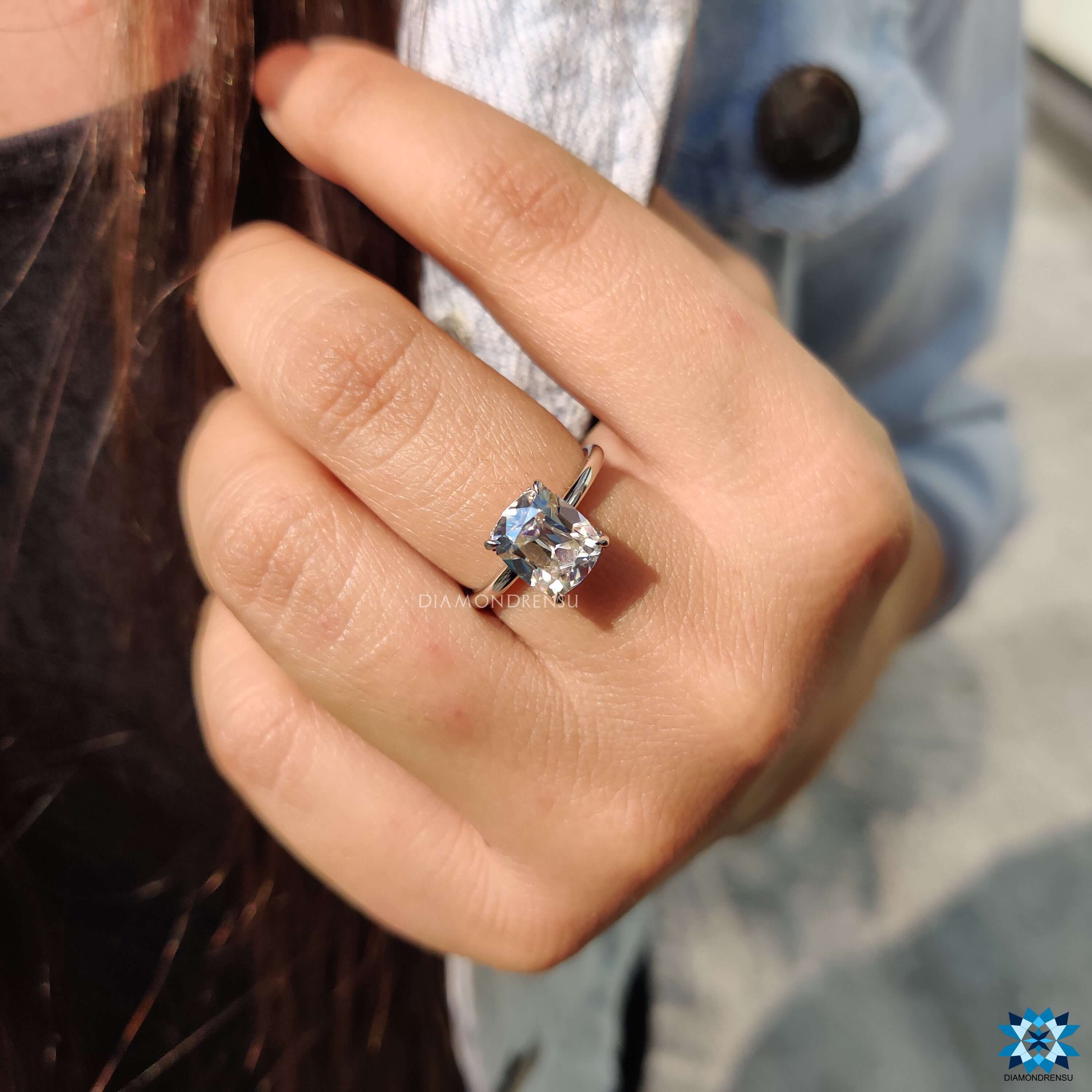 Cushion cut moissanite set in white gold band.