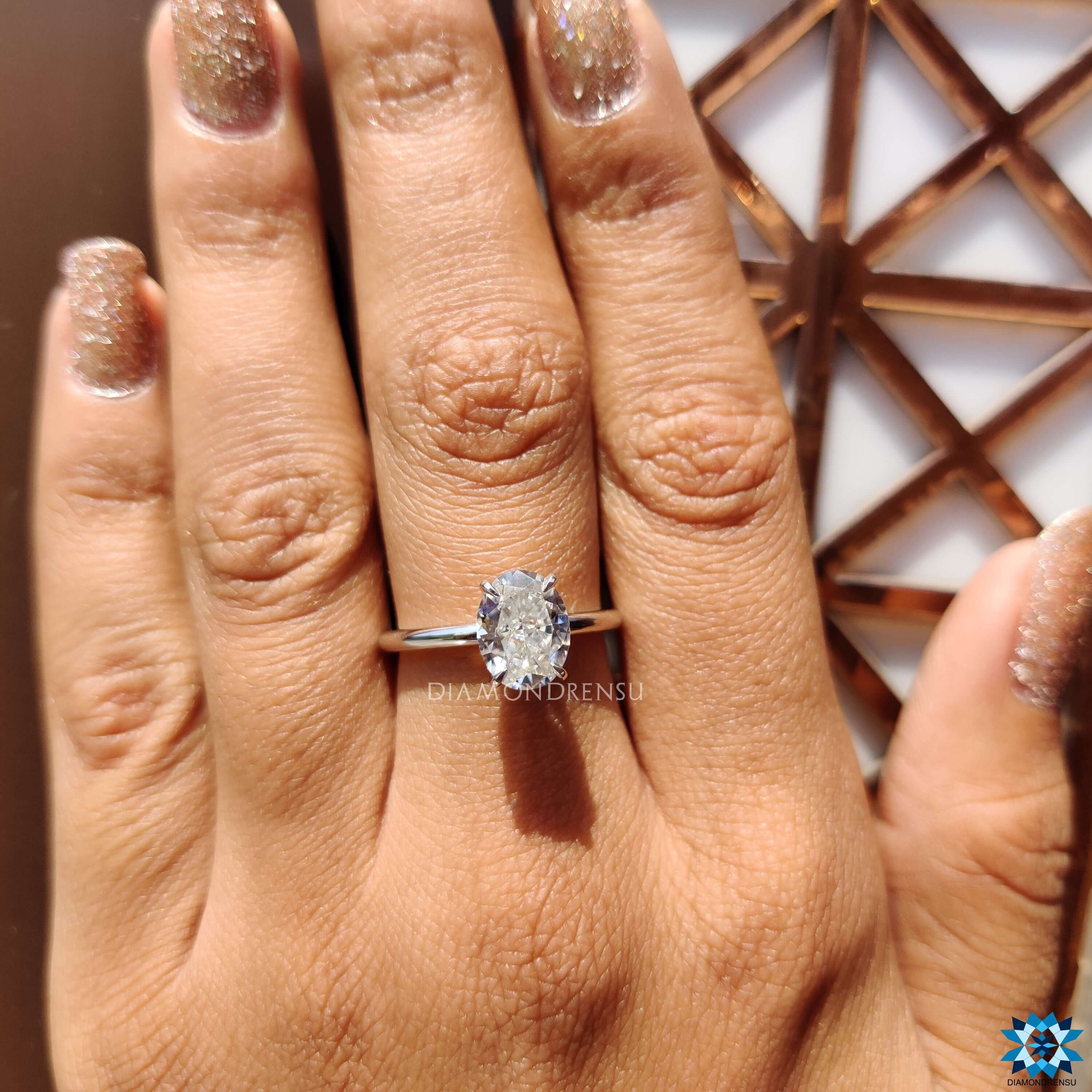 White gold ring with oval moissanite center stone.