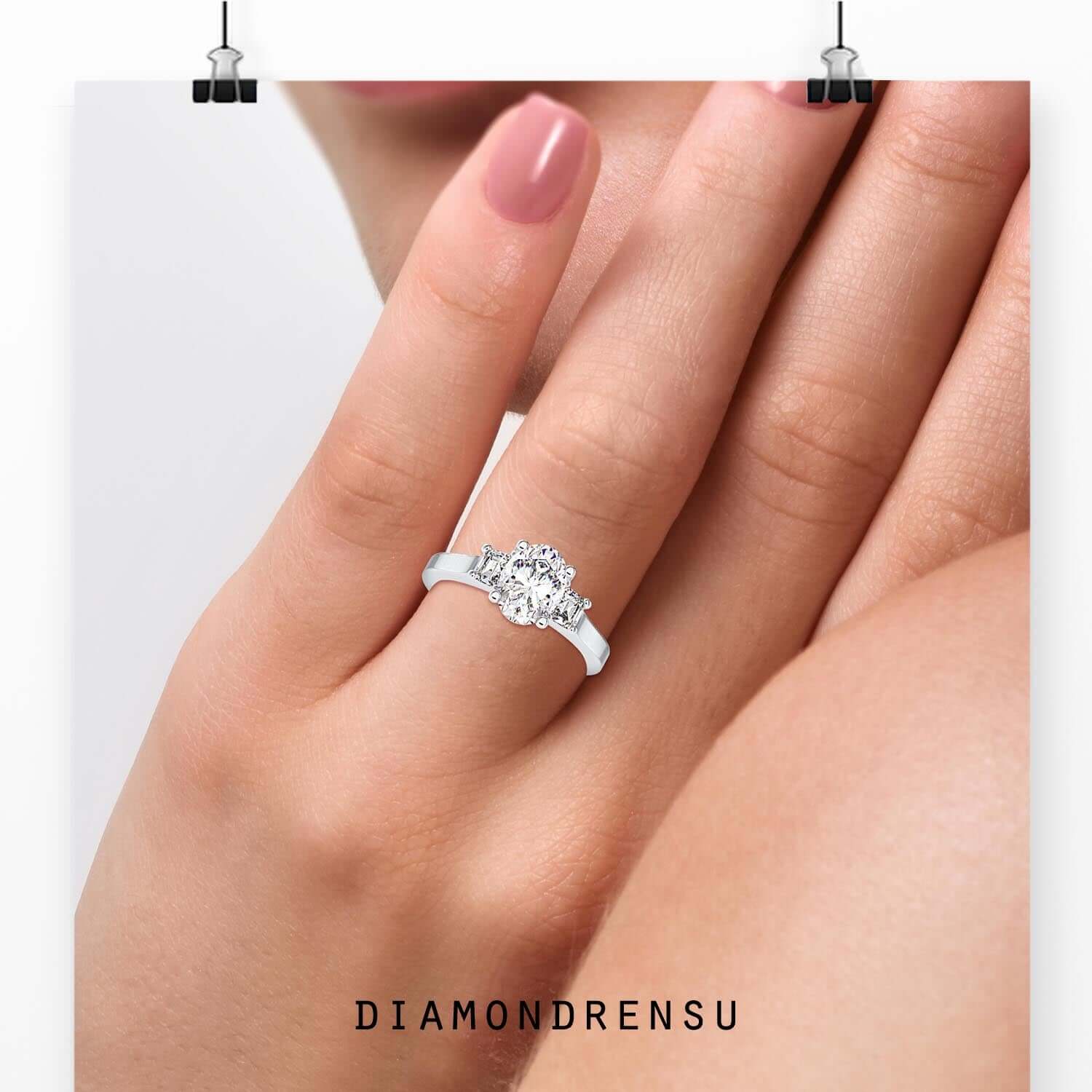 Oval centre diamond set in prong setting white gold band.