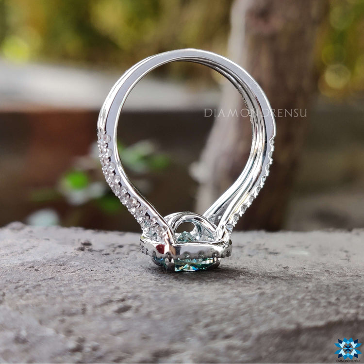 Prong setting holding cushion moissanite stone.