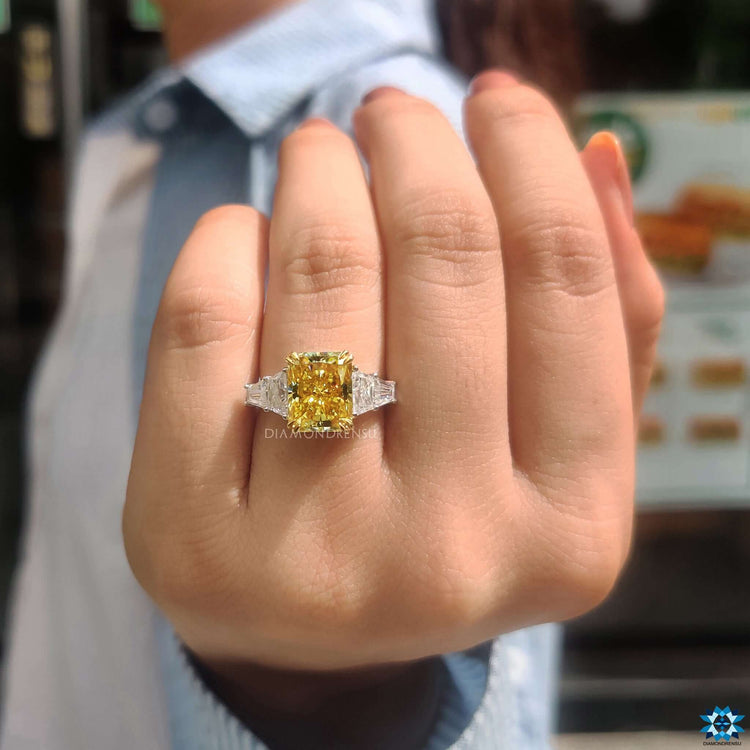 Engagement ring with trapezoid and tapered baguette side stones.