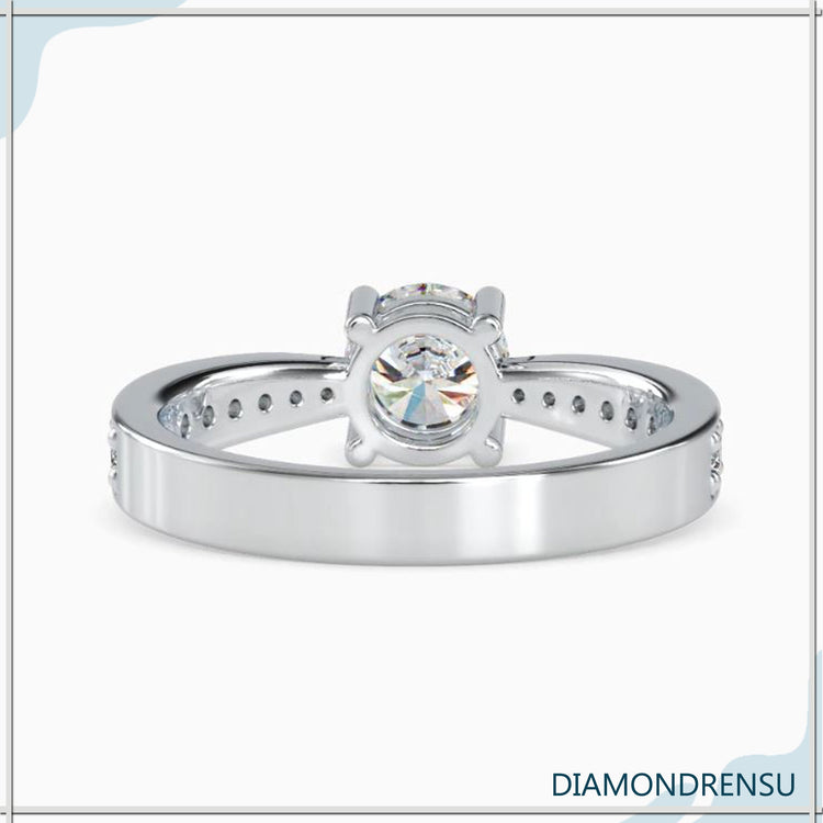 Simple diamond ring with four prong round cut setting.