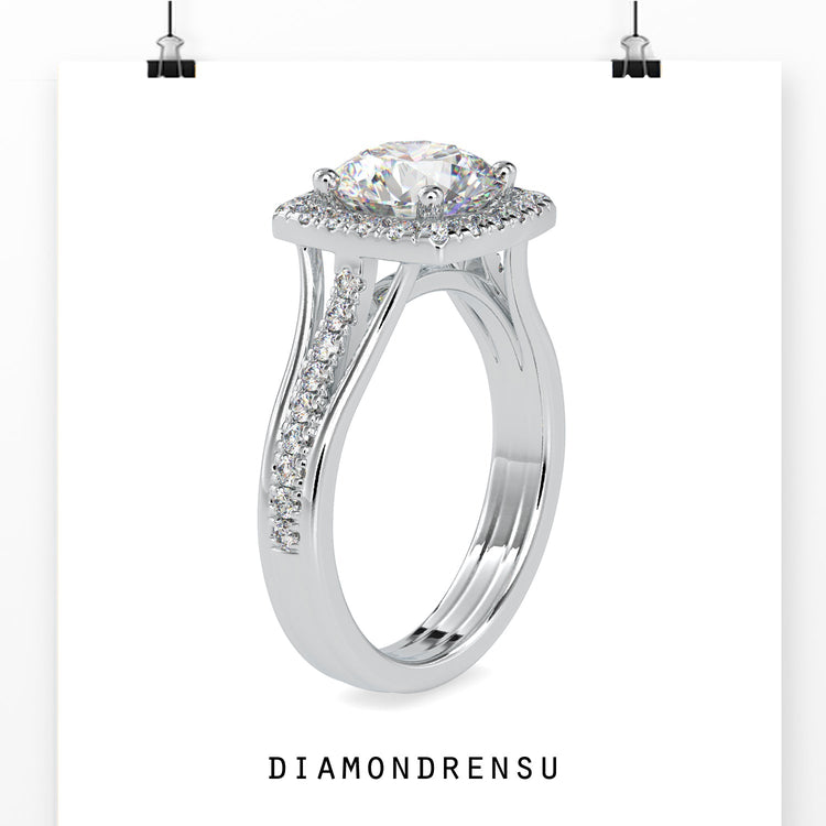 Designer ring with split shank and round diamond setting.