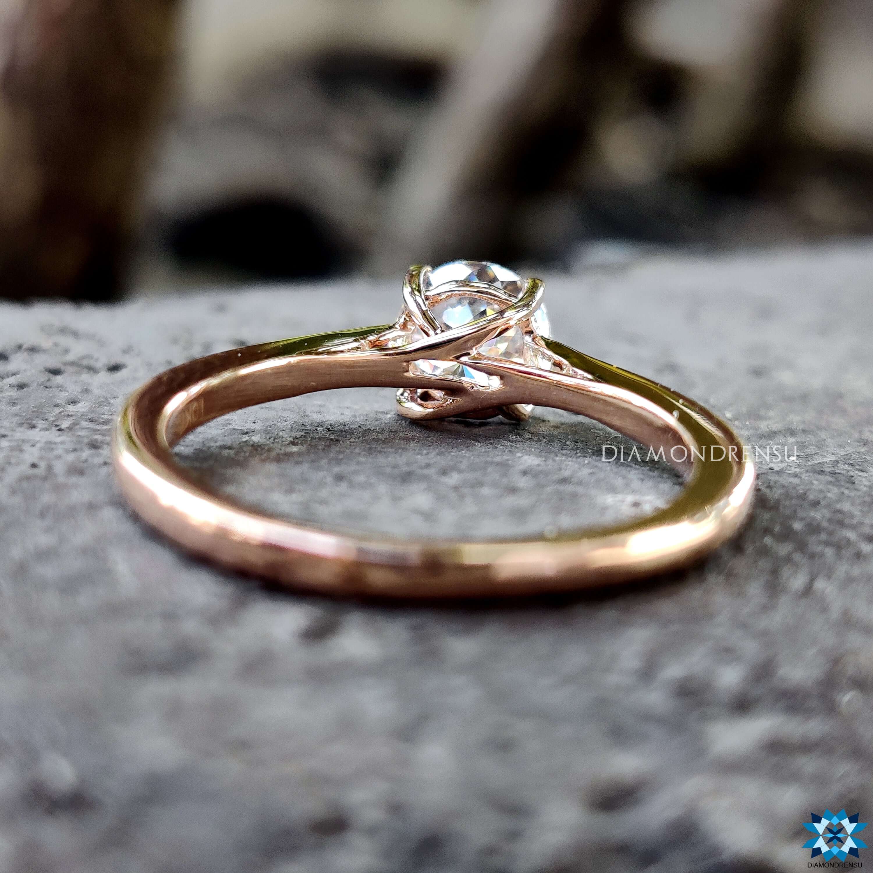 Four prong solitaire moissanite engagement ring.