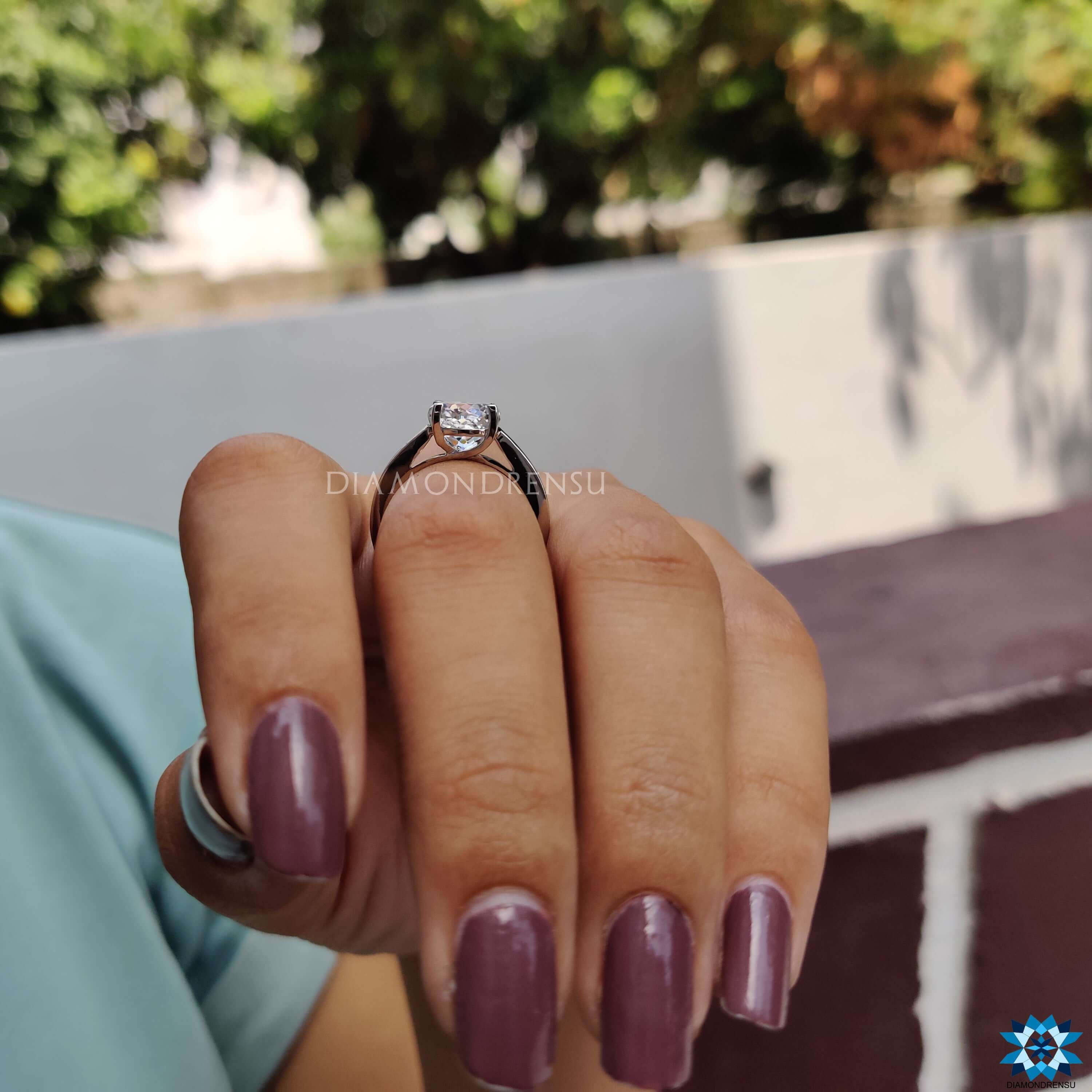 Simple engagement ring with precision cut moissanite.