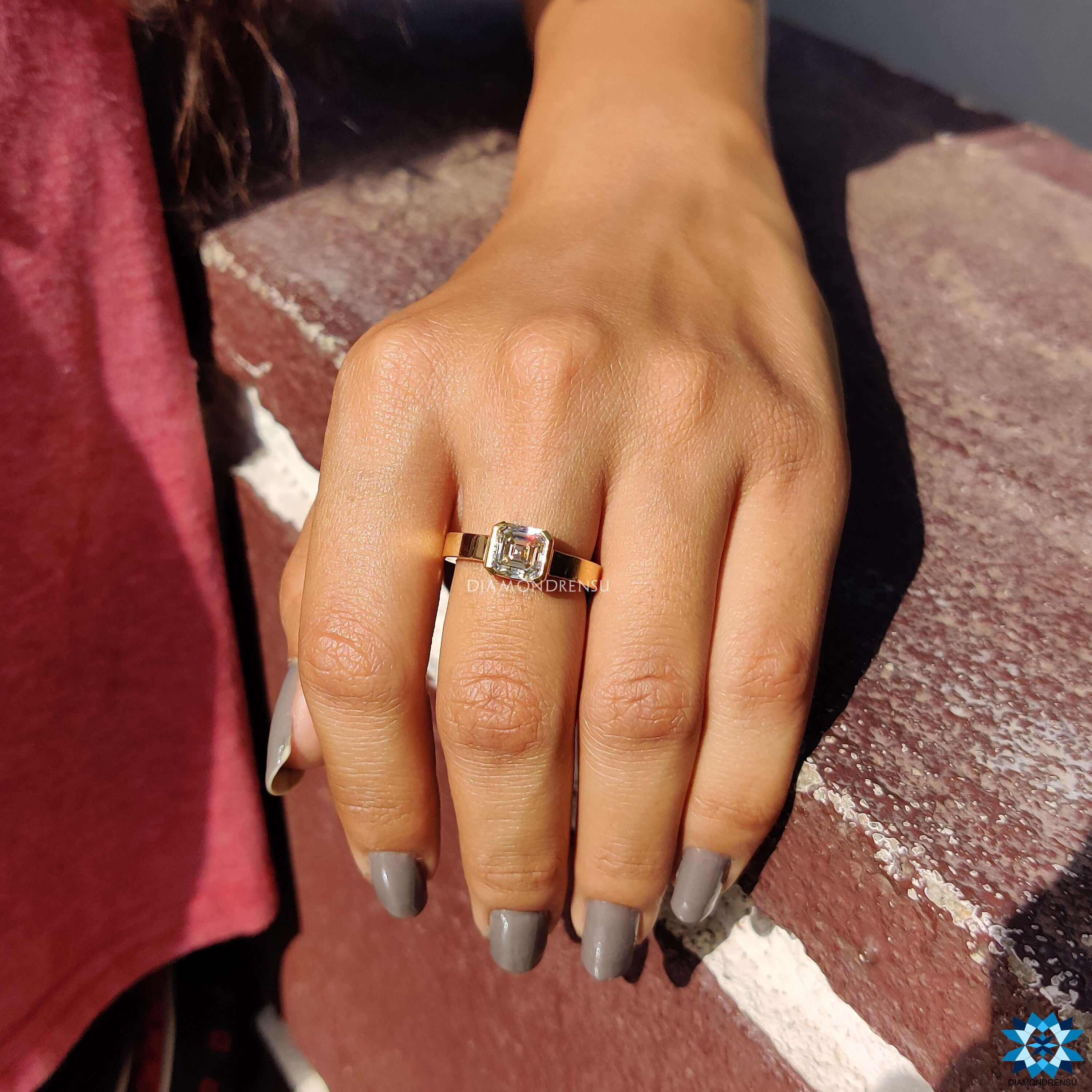 Half bezel setting on Asscher cut moissanite ring.