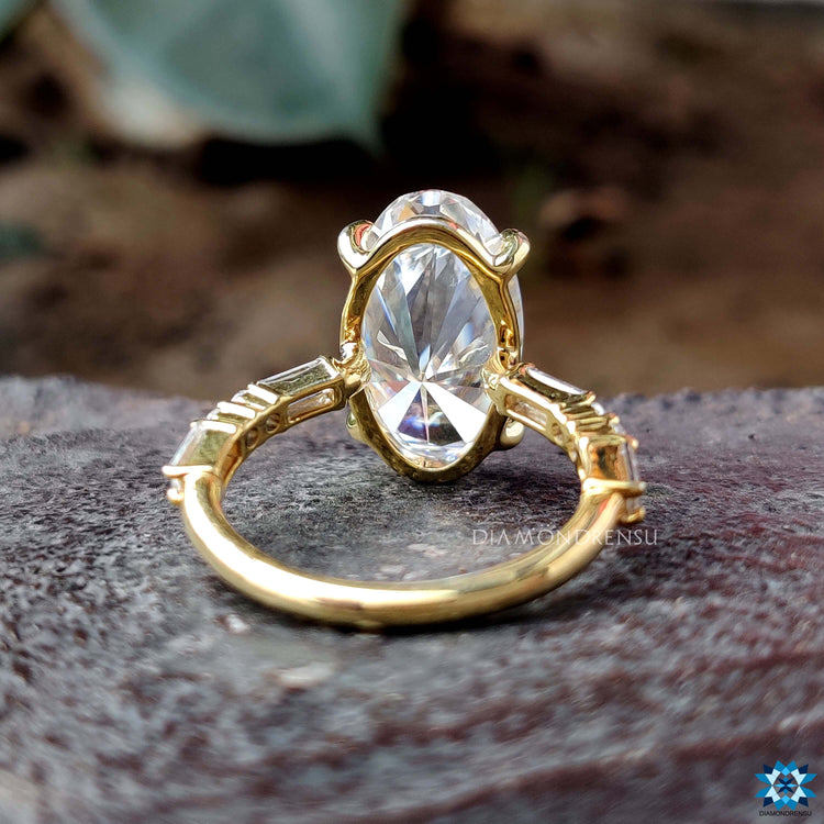 Buy moval cut moissanite ring with round and baguette side stones.